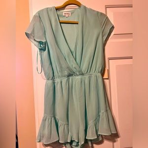 Seafoam green romper. Short sleeves. Ruffle shorts. Never worn.